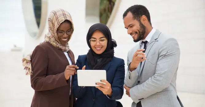 Image of 3 people looking at a tablet